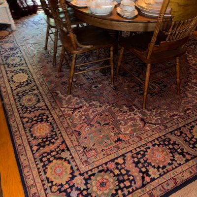 Sale Photo Thumbnail #126: Large Persian-style area rug with intricate floral motifs in pink, navy blue, and green, displayed beneath a wooden dining set.