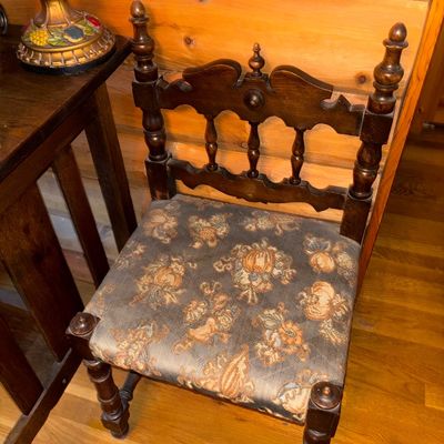 Sale Photo Thumbnail #10: Vintage Spanish Revival style wooden side chair featuring turned finials, carved backrest details, and floral tapestry upholstery.