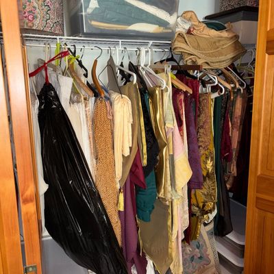 Sale Photo Thumbnail #60: Closet full of assorted textiles, vintage fabrics, and formal garments alongside clear plastic storage tubs and hat boxes.
