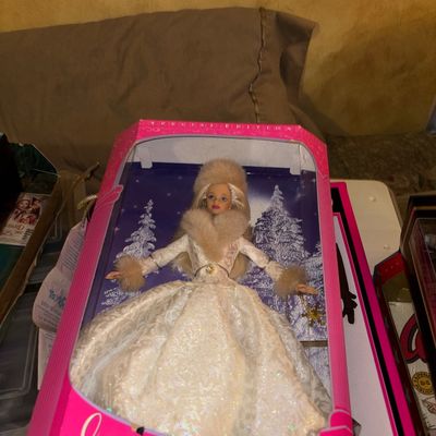 Sale Photo Thumbnail #99: 1998 Special Edition Winter Evening Barbie doll, unopened in its original pink packaging with faux-fur trim detailing on her white gown.