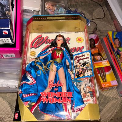 Sale Photo Thumbnail #102: Barbie as Wonder Woman Collector Edition doll, NRFB in original packaging, surrounded by other boxed fashion dolls.
