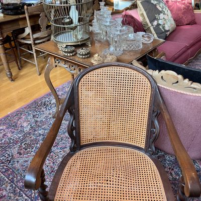 Sale Photo Thumbnail #39: Vintage dark wood armchair with woven cane back and seat, featuring twisted barley legs and carved accents.