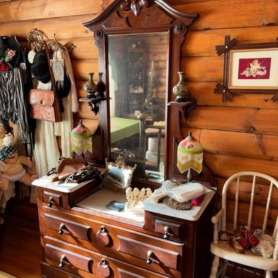 Sale Photo Thumbnail #61: Antique Victorian dark wood vanity dresser featuring a marble insert top, attached mirror with carved cresting, side shelves, and multiple drawers.
