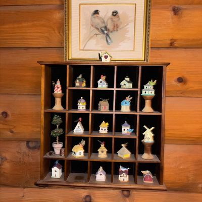 Sale Photo Thumbnail #22: Wooden shadow box display shelf filled with miniature birdhouses and a framed watercolor-style print of two birds mounted above.