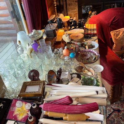 Sale Photo Thumbnail #21: Tabletop filled with assorted household items, including glassware, taper candles, small decorative trinkets, and framed art.