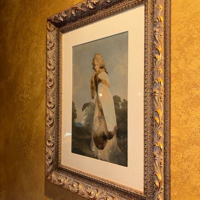 Sale Photo Thumbnail #41: Framed portrait print of an 18th-century style woman in fur attire, set in a heavily carved ornate silver and gold-tone frame with a white mat.