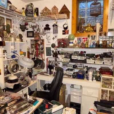 Sale Photo Thumbnail #106: Craft room filled with various art supplies, storage drawers, shelving units, desk lamps, and decorative collectibles.