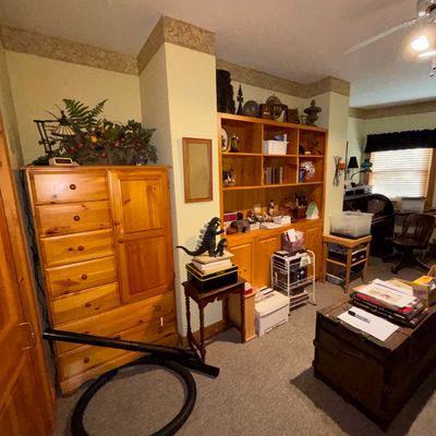 Sale Photo Thumbnail #29: Rustic pine furniture set including a tall armoire chest, large wall shelving unit, and dark wood trunk coffee table.