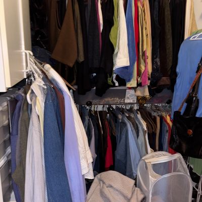 Sale Photo Thumbnail #44: Closet full of assorted men's and women's clothing, including shirts, jackets, and accessories on hangers.