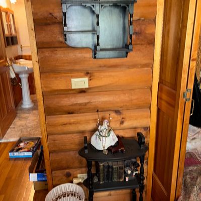 Sale Photo Thumbnail #59: Black painted wooden wall cabinet with a small glass door mounted above a matching black tiered accent table with spindle legs.
