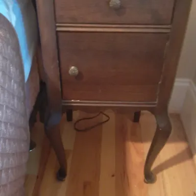 Vintage dark wood nightstand featuring French provincial style cabriole legs, a top drawer, and a lower cabinet door.