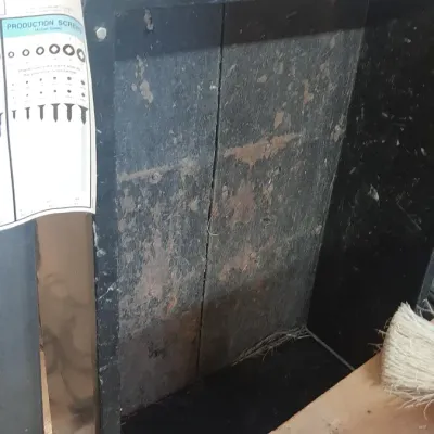 Heavy-duty black metal equipment cart showing significant surface wear and rust.
