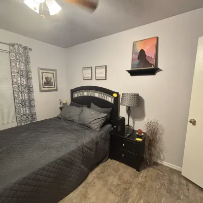 Sale Photo Thumbnail #31: Modern bedroom set featuring a dark wood queen bed frame with silver accents, matching two-drawer nightstand, and gray quilted bedding.