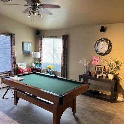 Sale Photo Thumbnail #35: Full-size wooden pool table with green felt top, complete with cues and a rack.