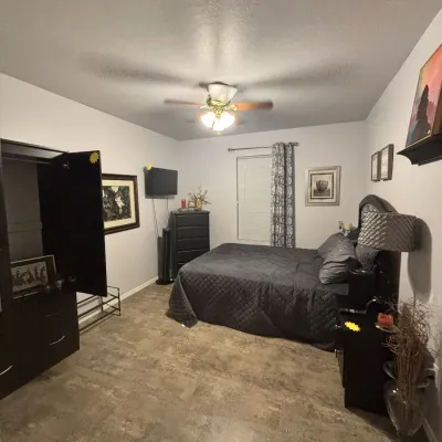 Sale Photo Thumbnail #30: Bedroom suite including a dark wood armoire, matching nightstands, a tall chest of drawers, and a queen-size bed frame.
