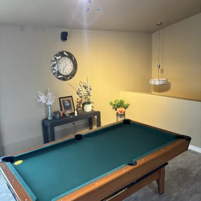 Sale Photo Thumbnail #38: Full-size pool table with green felt surface and wooden apron, positioned in a room alongside modern home furnishings.
