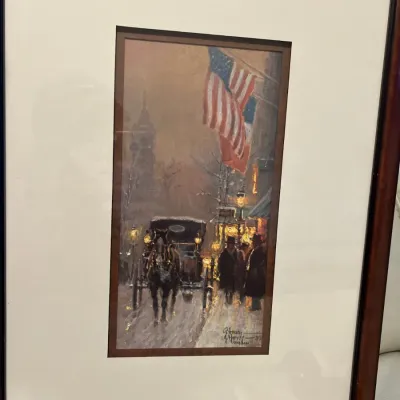 Sale Photo Thumbnail #33: Framed limited edition print by G. Harvey depicting a snowy street scene with a horse-drawn carriage and an American flag, double-matted in a dark wood frame.