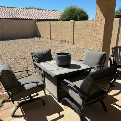Sale Photo Thumbnail #32: Modern outdoor patio conversation set featuring a tile-top fire pit table and four cushioned swivel armchairs.