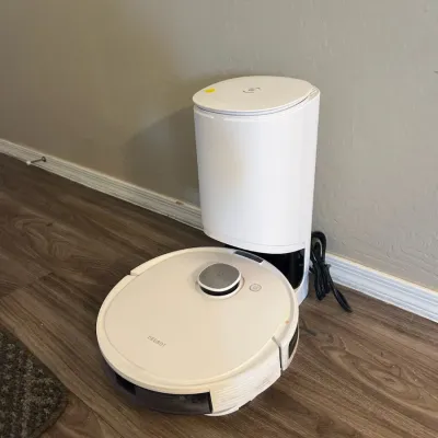 Sale Photo Thumbnail #8: White Ecovacs Deebot robotic vacuum cleaner with its auto-empty charging station.