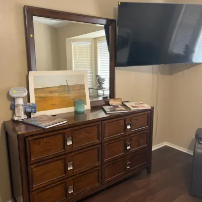 Sale Photo Thumbnail #15: Contemporary dark wood eight-drawer dresser with matching wall-mounted mirror, brushed metal pulls, and modern paneling details.