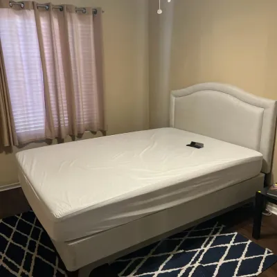Sale Photo Thumbnail #17: Contemporary queen-size bed frame featuring an upholstered arched headboard and light beige fabric finish, displayed on a geometric area rug.