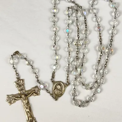 Vintage Catholic rosary featuring faceted Aurora Borealis crystal glass beads and a Sterling Silver crucifix with an ornate centerpiece.