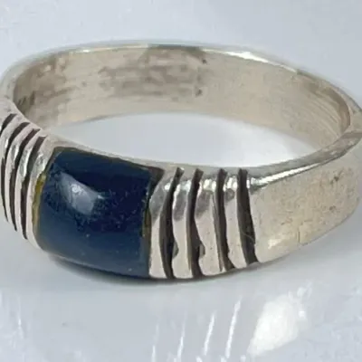 Sterling silver ring featuring a rectangular dark blue inlay stone fluted with vertical grooved accents along the band.