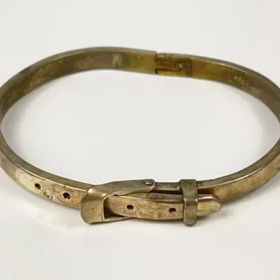 Vintage Sterling Silver belt buckle motif bangle bracelet featuring a front buckle clasp mechanism.