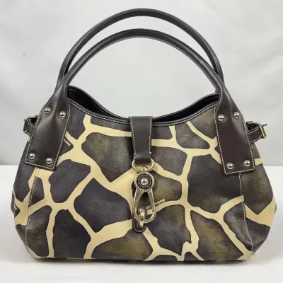 Dooney & Bourke giraffe print leather handbag featuring dark brown leather trim, double handles, and silver-tone hardware including a...