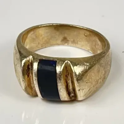 Men's vintage Sterling Silver band ring featuring a flush-set rectangular dark blue gemstone flanked by carved ribbed details.