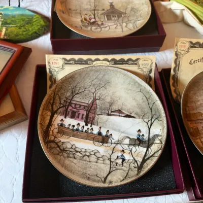 Set of Ann Perrott limited-edition collector plates featuring vintage winter scenes, complete with original boxes and certificates of...
