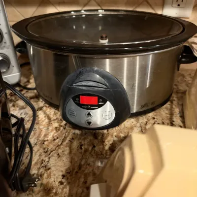 Crock-Pot Smart-Pot oval slow cooker with a brushed stainless steel finish and digital control panel.