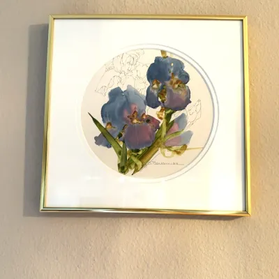 Framed floral watercolor print featuring purple irises within a circular mat, signed J. Barsumian in a thin gold-tone metal frame.