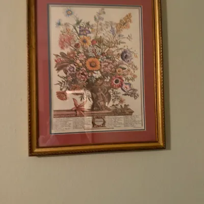 Framed vintage botanical art print featuring a colorful floral arrangement, housed in a ornate gold-toned frame with a double mat.