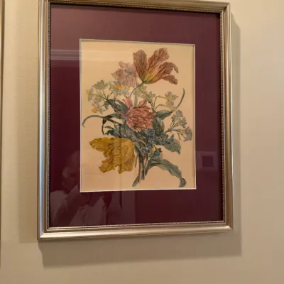 Framed botanical floral print featuring tulips and mixed flowers, presented with a double burgundy mat in a silver-toned beaded frame.
