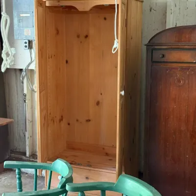 Sale Photo Thumbnail #285: Tall light knotty pine wardrobe armoire, featuring double doors, an open main interior section, and a lower drawer.