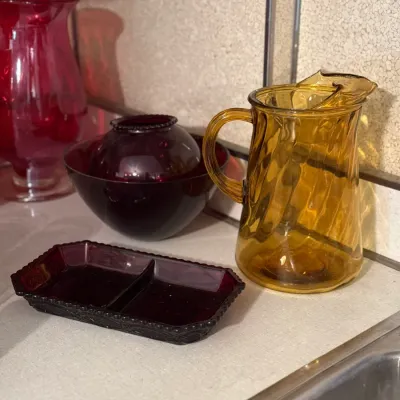 Sale Photo Thumbnail #5: Vintage glass kitchenware set, including an amber swirl pitcher, a ruby red divided dish, a ruby red vase, and a matching dark red glass bowl with a globe vase.