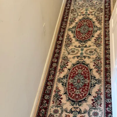 Sale Photo Thumbnail #27: Traditional Persian-style hallway runner rug with intricate floral motifs and central oval medallions in shades of cream, burgundy, and green.