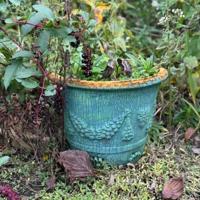 Sale Photo Thumbnail #201: Weathered turquoise glazed ceramic planter featuring embossed swags and a distressed finish.