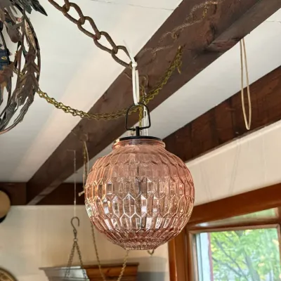 Sale Photo Thumbnail #123: Vintage pink textured glass globe hanging lantern suspended from a decorative ceiling chain.