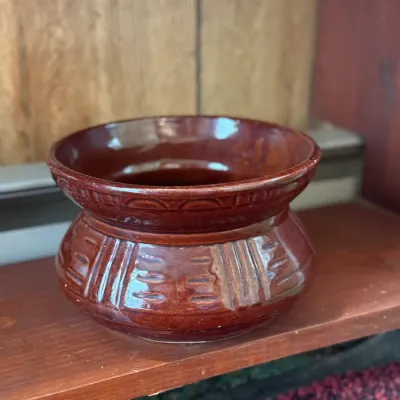 Sale Photo Thumbnail #174: Brown glazed ceramic African violet planter with an embossed pattern around the rim and base.