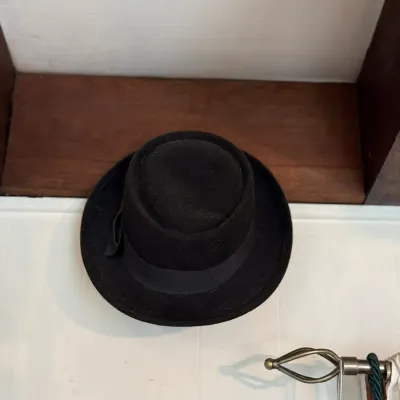 Sale Photo Thumbnail #133: Vintage black wool felt fedora featuring a matching grosgrain ribbon hatband with side bow detail.