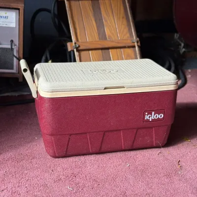 Sale Photo Thumbnail #231: Vintage Igloo maroon and off-white plastic ice chest cooler with side handles.
