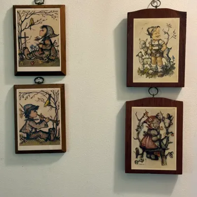 Sale Photo Thumbnail #50: Four vintage Hummel-style framed art plaques mounted on wood, featuring illustrations of children in traditional attire.