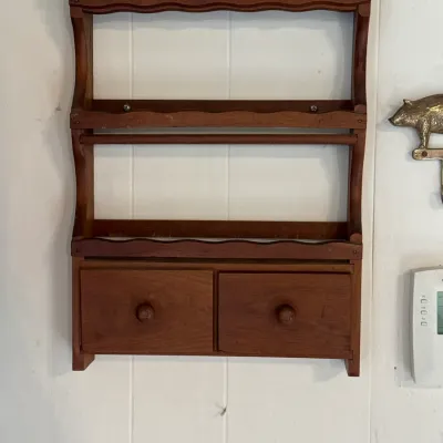 Sale Photo Thumbnail #100: Vintage wall-mounted wooden spice rack with scalloped trim, two shelves, and two small storage drawers at the bottom.