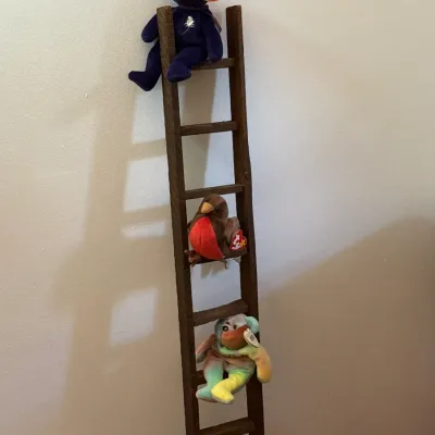 Sale Photo Thumbnail #34: Rustic dark wood miniature decorative ladder displayed with three Ty Beanie Babies, including a Princess Diana memorial bear, resting on its rungs.