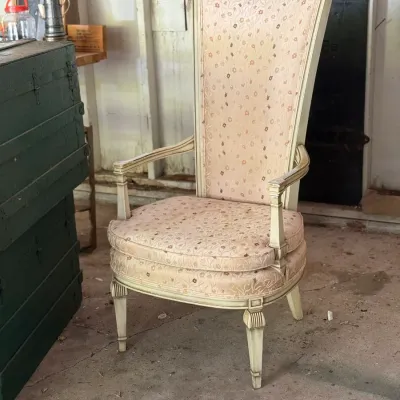 Sale Photo Thumbnail #255: French Provincial style high-back armchair featuring an off-white distressed painted frame and floral brocade upholstery.