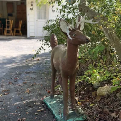 Sale Photo Thumbnail #238: Vintage life-size buck deer lawn ornament mounted on a base, showing painted finish with light outdoor weathering.