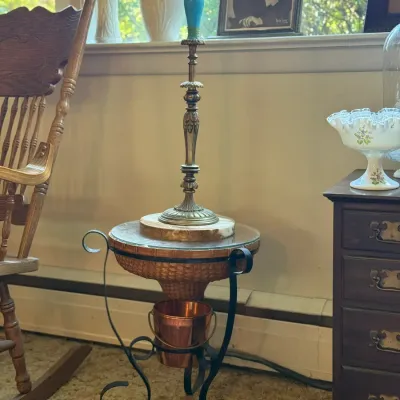 Sale Photo Thumbnail #85: Vintage brass and turquoise table lamp resting on a unique wrought-iron end table with a copper planter insert.