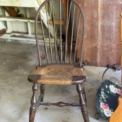 Sale Photo Thumbnail #265: Vintage dark-stained Windsor-style side chair featuring a woven rush seat and turned legs.